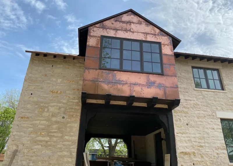 Copper metal panel facade on a stone building for Skylight Installation in Lakeville